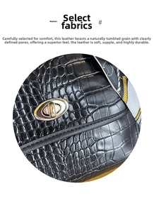 Close-up of black crocodile pattern leather bag with silver oval twist lock and silk scarf