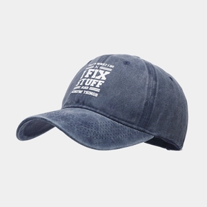 Close-up of vintage blue washed cotton baseball cap with white retro quote embroidery
