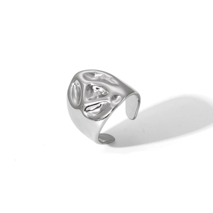 Detail of silver irregular hammered texture on adjustable stainless steel ring