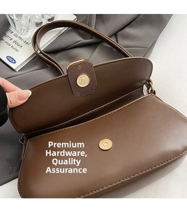 Close-up of vintage dark brown leather bag with premium gold magnetic hardware and buckle