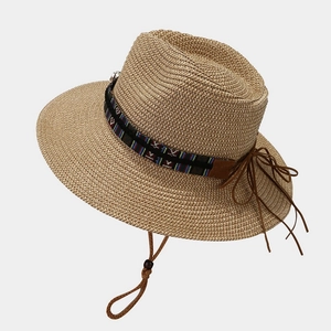 Panama straw hat with ethnic woven band and windproof string on white background