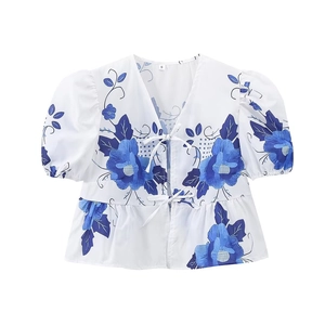 Women's white linen V-neck short sleeve shirt with blue floral print and bow ties