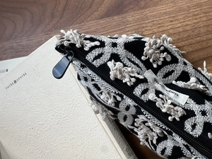 Close-up of butterfly embroidery and texture on canvas bag with simple wish label