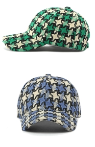 Detailed view of thick knit houndstooth baseball caps in green and blue tweed texture