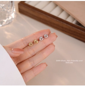 Detail of S999 sterling silver rose stud earrings in gold and silver finishes