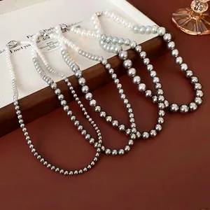 Elegant French pearl necklace set featuring gradient white to dark grey pearls and metal clasp