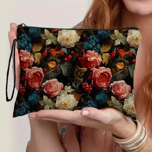 Floral print cosmetic bag with vintage rose patterns and a black portable wristlet strap