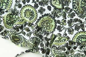 Close-up of green floral paisley crepe fabric with ruffle details and slim drawstring tie