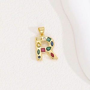 Detailed view of golden letter R pendant featuring vibrant multi-colored baguette crystals
