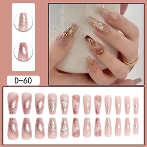 Nude pink press-on nails with gold foil and marble design in long ballerina shape