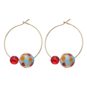 Gold hoop earrings with translucent red beads and blue resin balls with orange dots