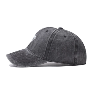 Detail view of washed grey cotton baseball cap showing vintage texture and curved brim
