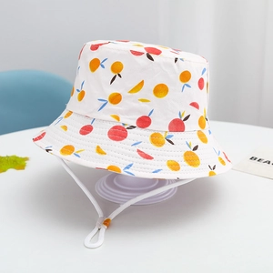 Detail of children's cotton sun hat featuring vibrant fruit patterns and windproof strap