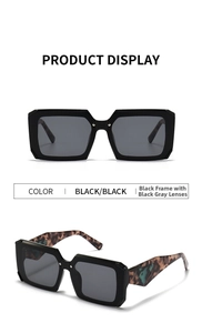 Macro detail of square black frame sunglasses featuring tortoiseshell patterned temples
