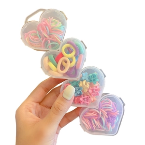 Handheld heart-shaped boxes with macaron color flower clips and elastic hair ties