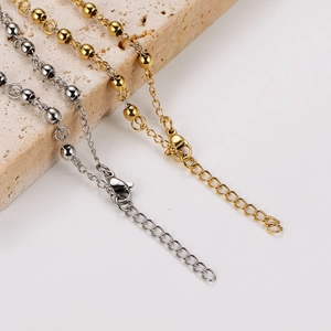 Detail view of adjustable extender chain and lobster clasp on stainless steel bracelet