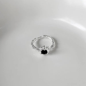 Macro shot of S925 sterling silver ring with black zircon and lava texture detail