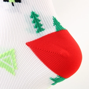 Detail of Christmas compression sock showing knitted tree patterns and red heel seam