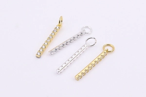 Detailed view of rectangular micro-pave cubic zirconia bar pendants in silver and gold