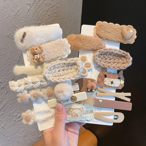 Detail of plush brown hair ties and clips featuring cute bear and heart designs