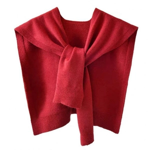Detail of red knitted shawl showing ribbed cuffs and cross-knot tying style