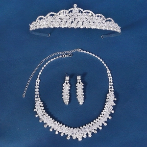 Detailed view of silver bridal jewelry set with sparkling rhinestones on blue background