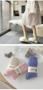 Close-up of thick knitted wool socks in cream, pink and blue with ribbed texture