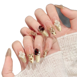 Handmade amber press-on nails featuring floral carving and leopard print cat eye design
