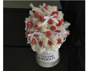 Close-up of strawberry bouquet in silver metal bucket with white bows and pearl beads