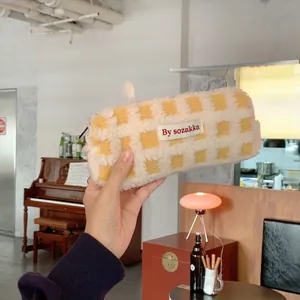 Close-up of yellow and white checkered fleece pencil case with soft waffle texture