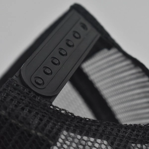Detail of black snapback closure and breathable mesh on a baseball trucker cap