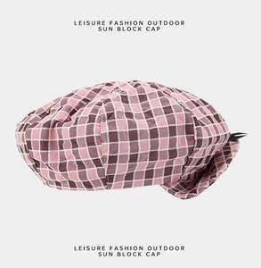 Close-up of pink and brown plaid weave texture on a leisure denim beret sun hat