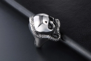 Detailed side view of punk stainless steel skull ring with coiled snake design