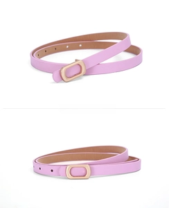 Close-up of slim pink PU leather belt with a rose gold rectangular metal buckle