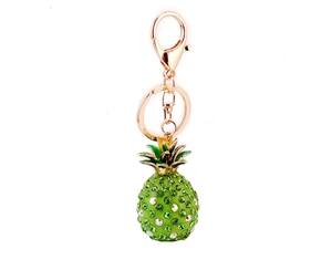 Detail of pineapple keychain with sparkling green and white crystals on gold alloy