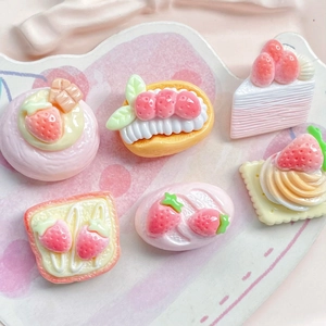 Macro view of six cute strawberry resin dessert miniatures for DIY hair clips and crafts