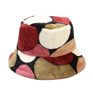 Plush winter bucket hat with colorful polka dot patchwork design for women in cold weather