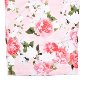 Detailed macro view of pink floral pattern and soft breathable fabric texture on long dress