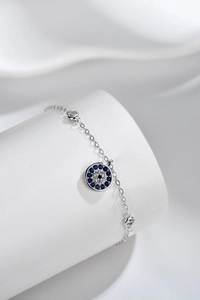 Macro detail of S925 sterling silver evil eye bracelet with blue and white gems