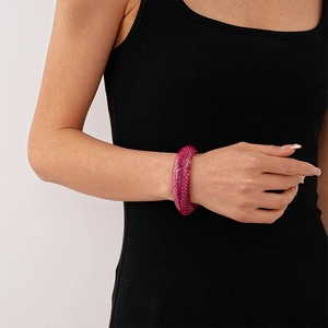 Detail of artistic berry red resin cuff bracelet with marble texture worn on wrist