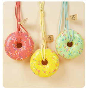 Dettaglio di ciambelle colorate in schiuma PU con zuccherini e targhette fatte a mano