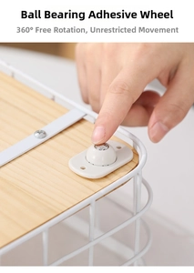 Close-up of universal adhesive swivel caster wheel installed on a storage basket bottom