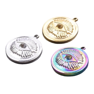 Three evil eye pendants in silver, gold, and rainbow finishes on a white background