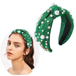 Detail of green knotted fabric headband with white pearls and sparkling rhinestones