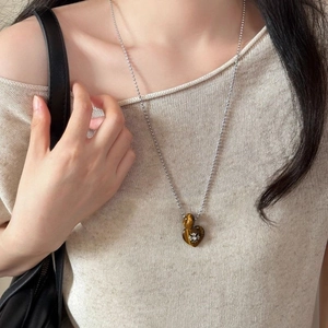 Vintage heart shaped tiger eye necklace with silver cross on bead chain model view