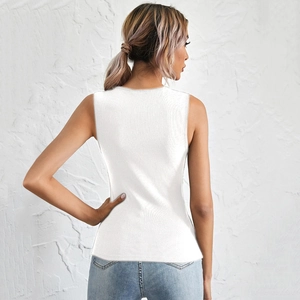 Rear view of a slim-fit white ribbed knit tank top paired with light blue denim jeans