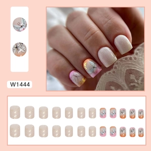 Short square press-on nails with pink butterfly designs, glitter, and gold foil accents