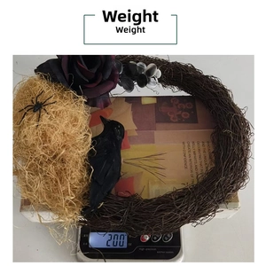 Weight measurement of a Halloween black rose and crow wreath on a digital scale