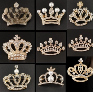 Detail of nine gold crown brooches featuring elegant white pearls and sparkling rhinestones