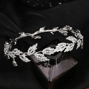 Detailed close-up of silver bridal crown with leaf design and sparkling rhinestones